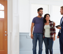 Couple with realtor looking at home