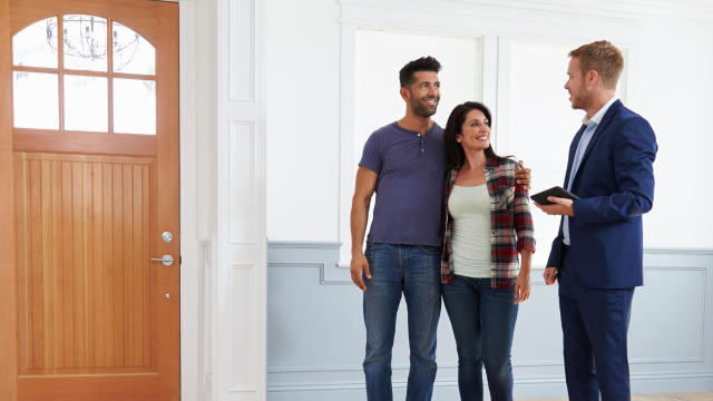 Couple with realtor looking at home
