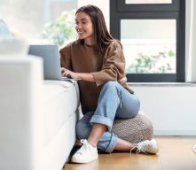 Young Woman on Computer in her Condo