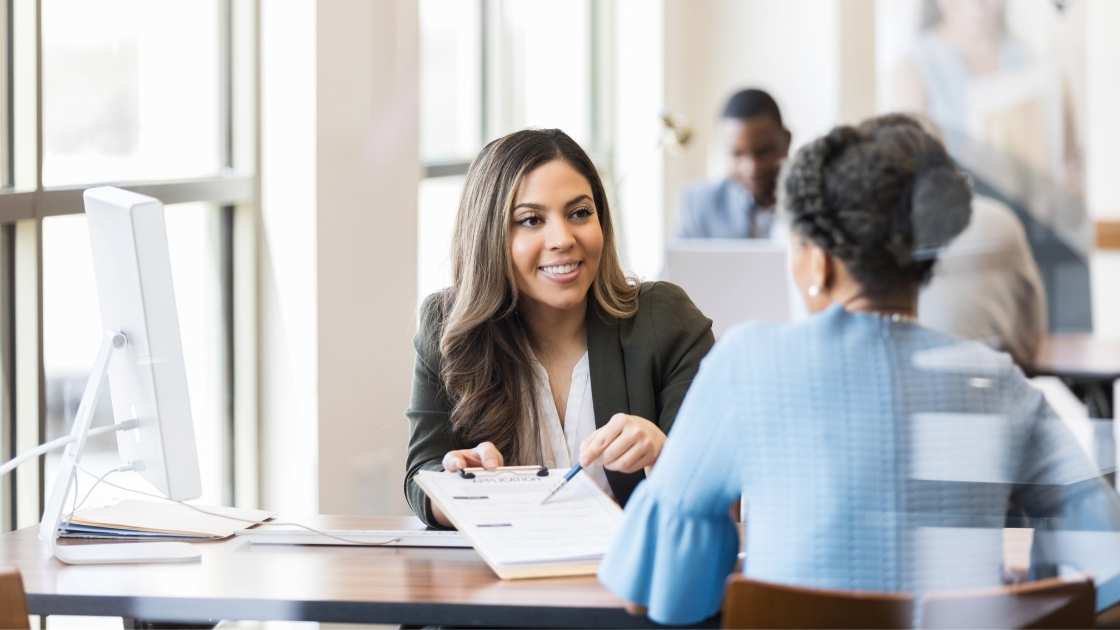 Mortgage loan officer reviewing paperwork with client