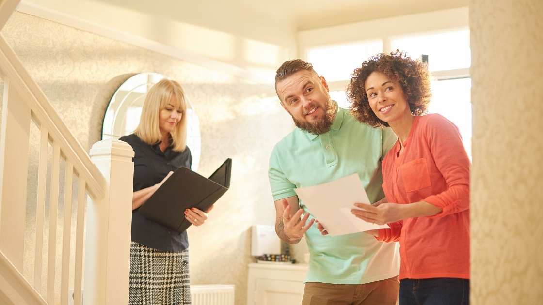 Couple touring home with a real estate professional