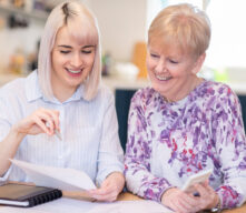 Older lady gifting money to great granddaughter