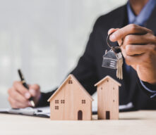 Person Holding Keys with House Keychain.