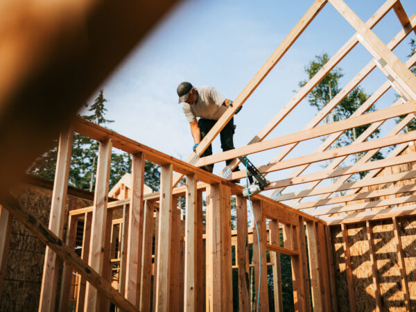 Construction worker putting framing up of a new home.