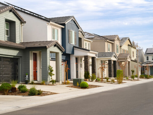Street of two-story homes in a housing development.