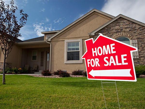 House with home for sale sign in yard